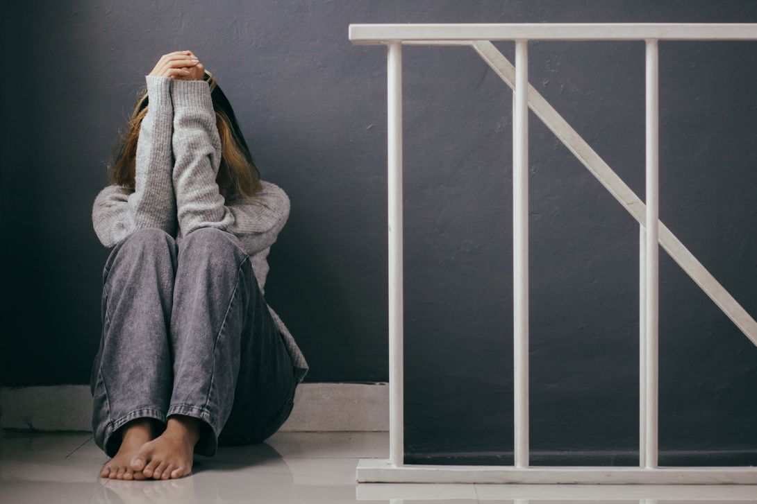 a woman who takes some m365 pills is seen here depressed near the white stairs