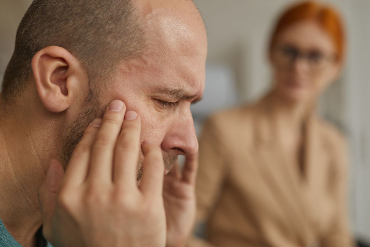 a mature man severely depressed and speaking to a depression treatment center personnel