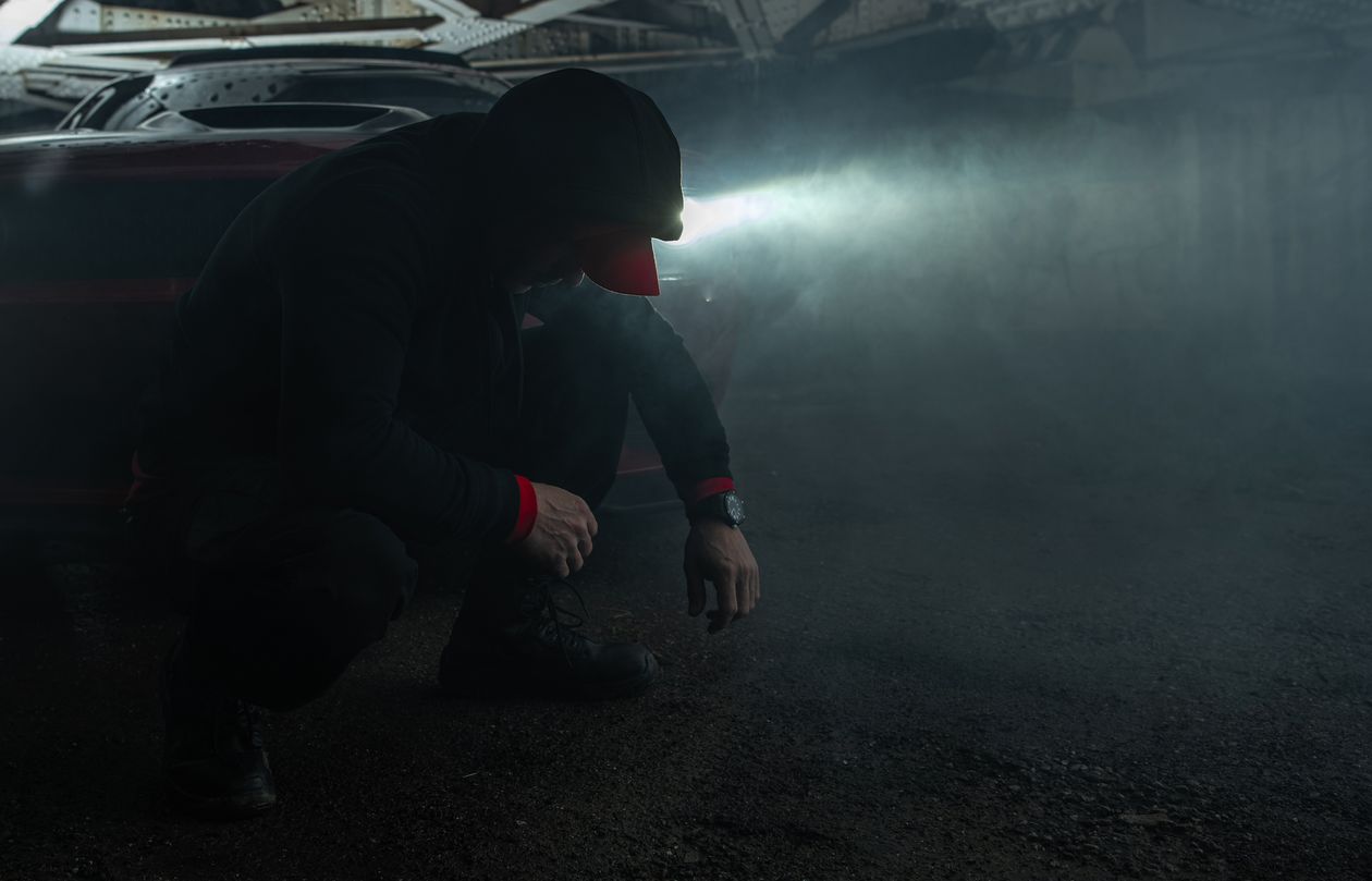 a man addicted to Suboxone is sitting in front of his car