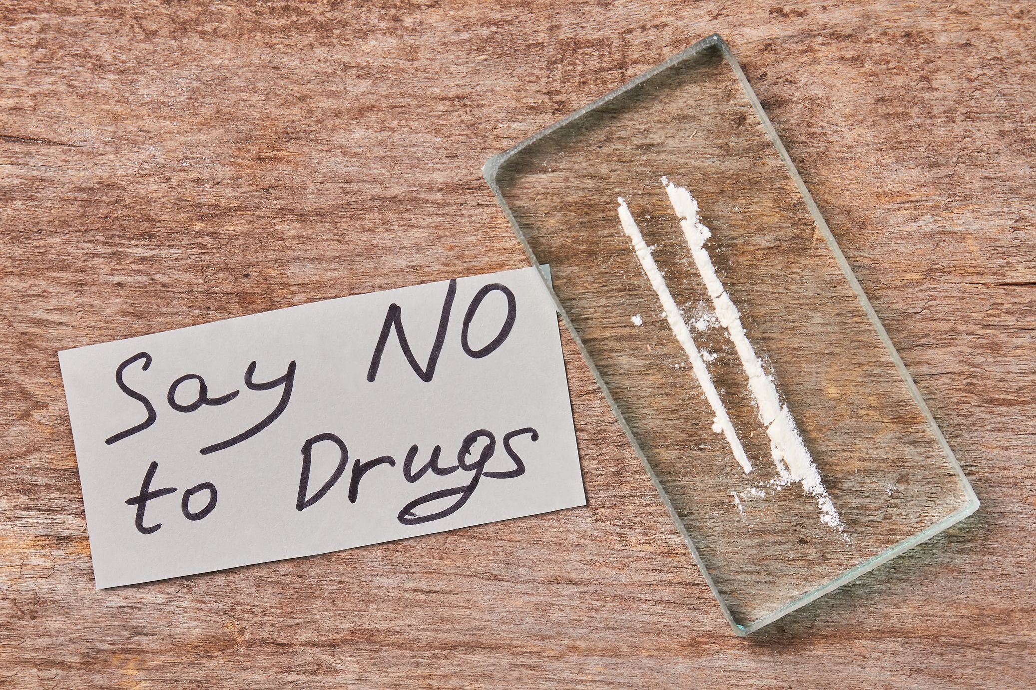 a Methamphetamine on a glass with a say not to drugs slogan