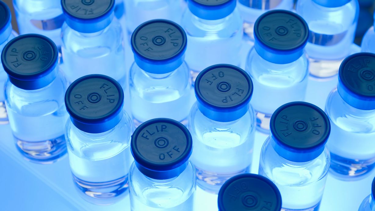 a bunch of ketamines in vials with a blue light