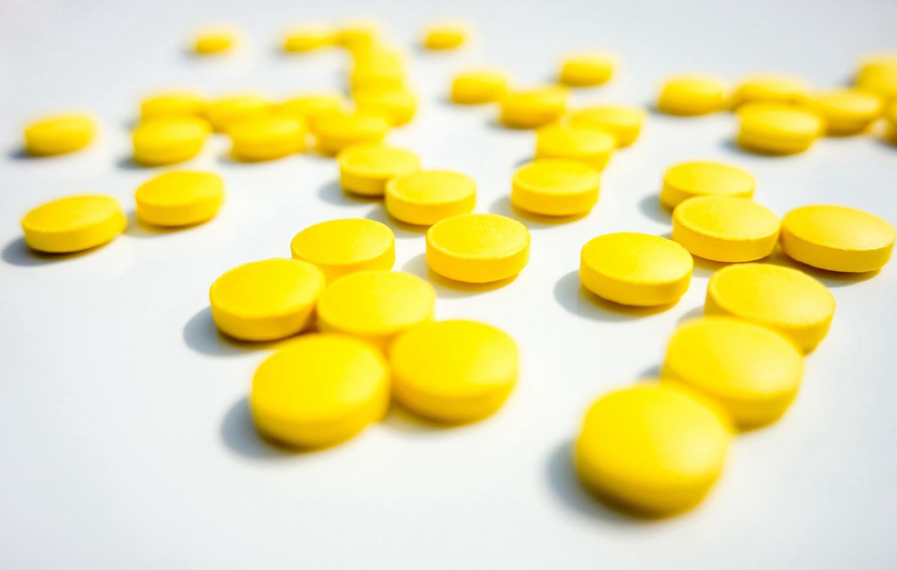 yellow pcp pills on a table