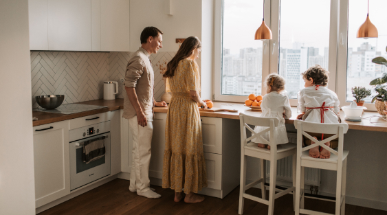 Family in the kitchen with their 2 kids helping