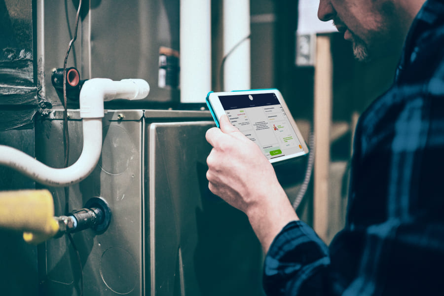 Technicien qui tient une tablette avec des données sur un équipement