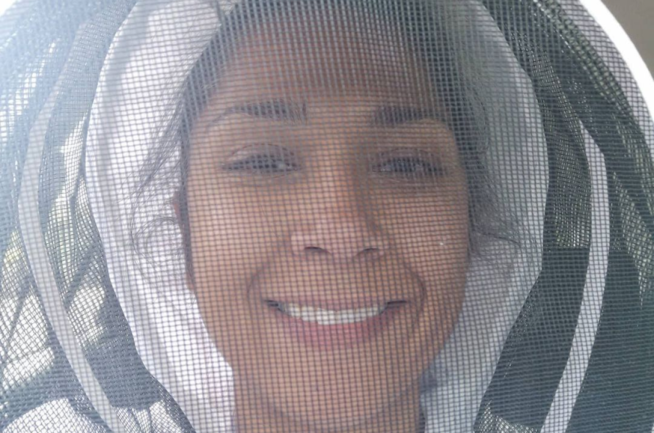 Zaffrin O'Sullivan wearing a beekeeper suit and smiling
