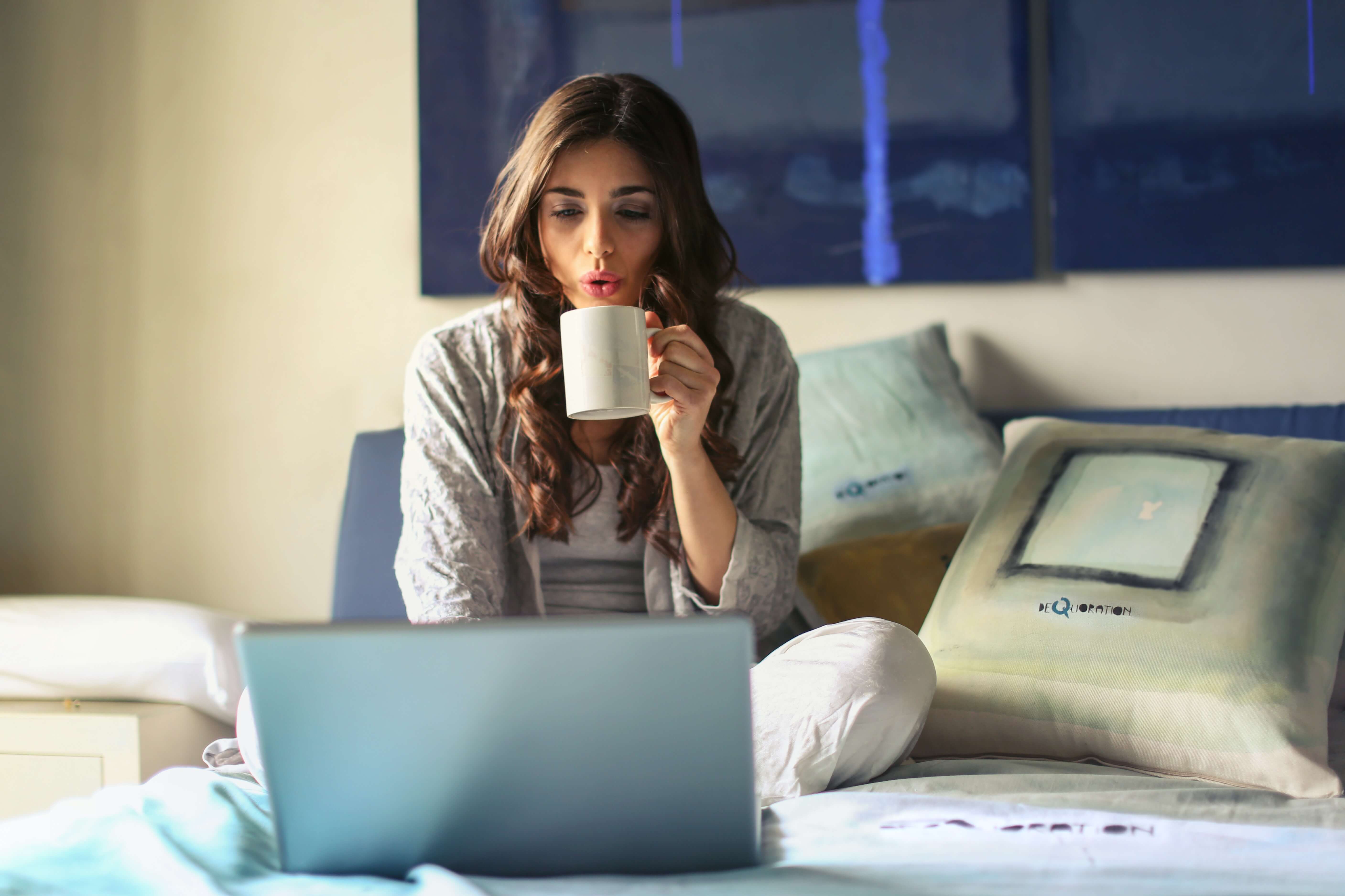 A girl using online selling tools and drinking coffee