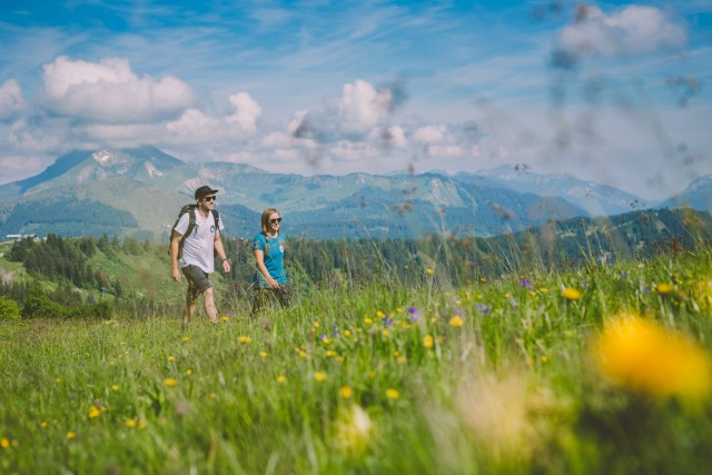 couple walk through mountains on holiday in morzine