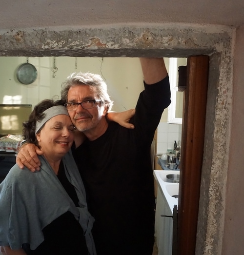 Carol Panaro-Smith and James Hajicek with arms wrapped around each other in Italy