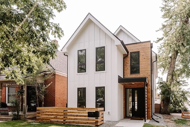 A white two story house on a sunny day in a nice area