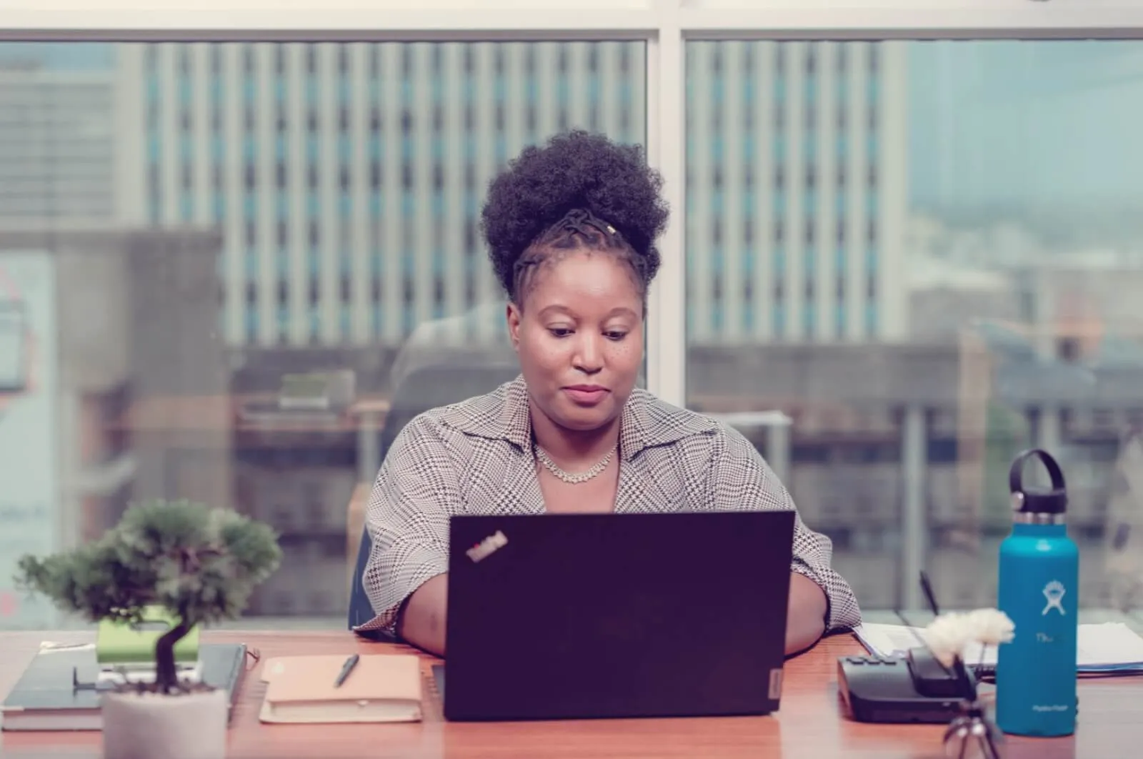 Thembi Bheka (CEO of Digital Marketing on Demand) working on a laptop