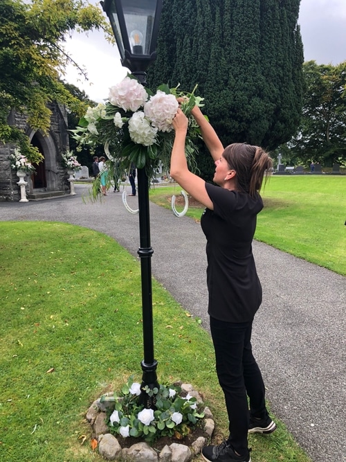 Elaine putting up floral display