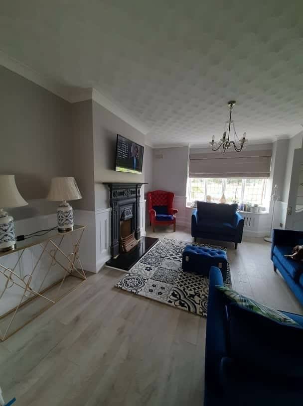 Image of sitting room with wooden floors and white panelling
