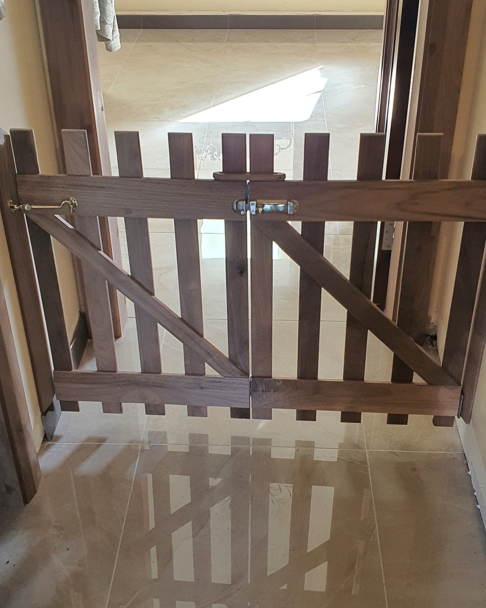 Image of brown safety gate in doorway 