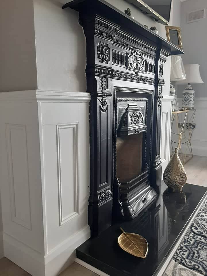 Image of white panelling and black fireplace