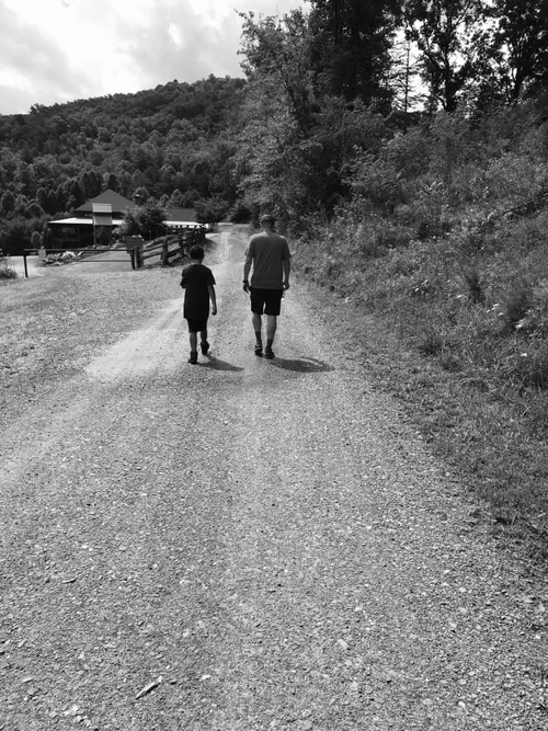 picture of two people walking up a trail