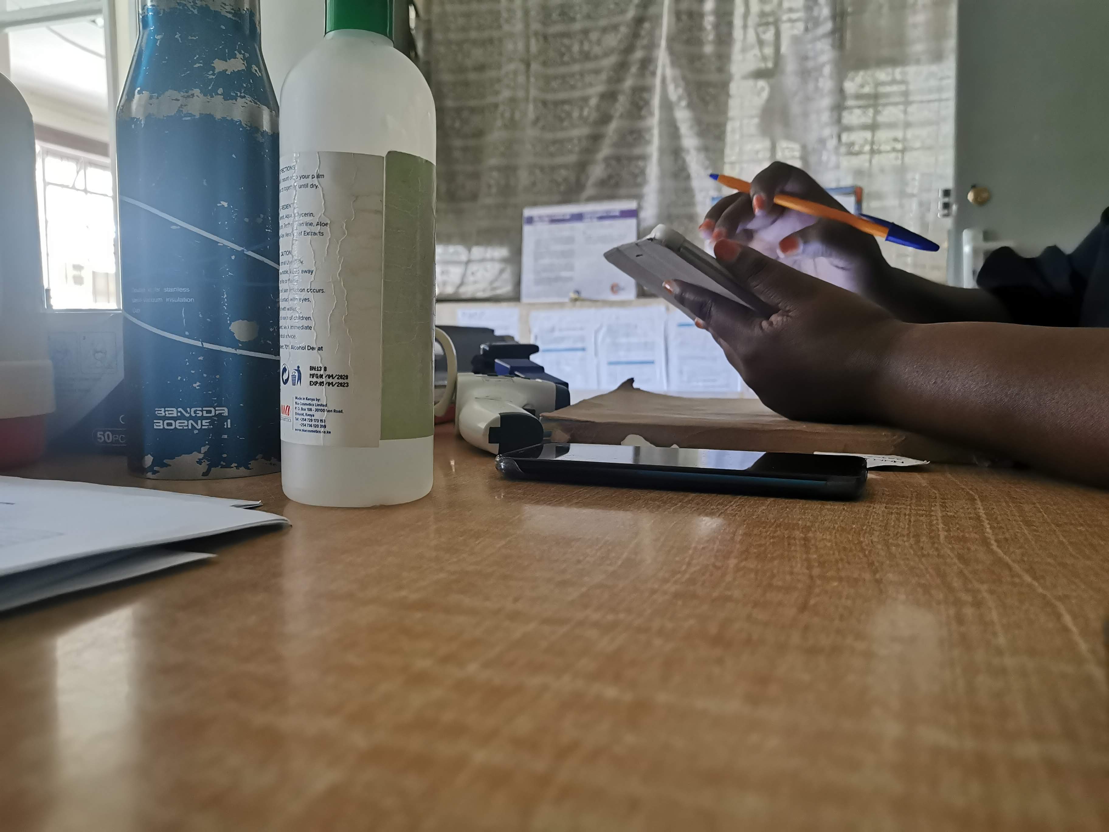 A triage nurse in Kenya uses OpenMRS to record patient blood pressure