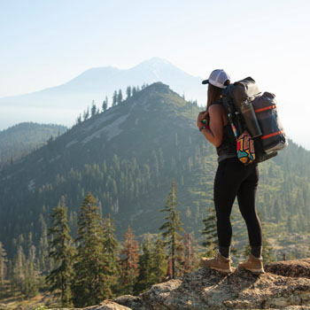 Girl hiking on top of hill