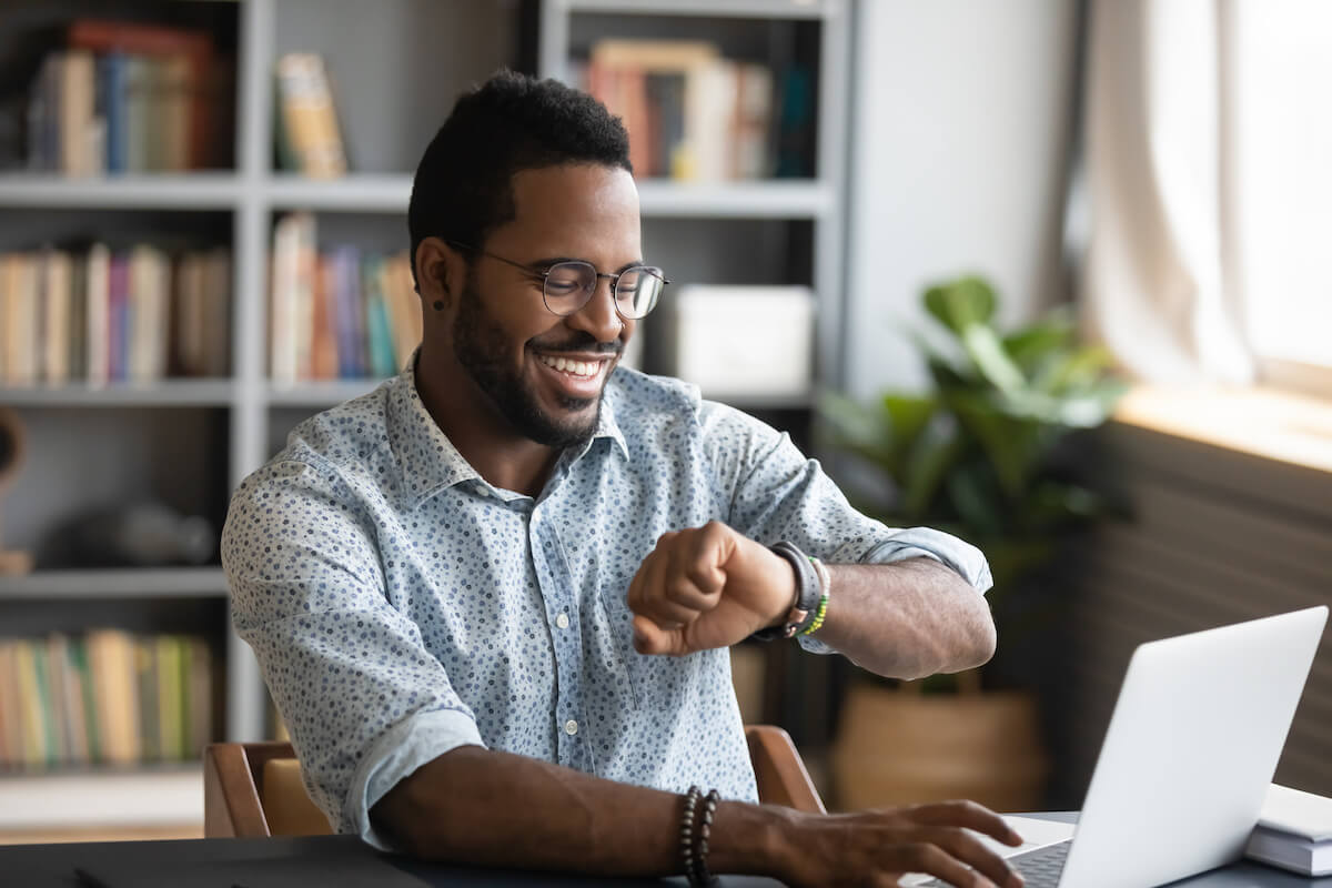Man happily looking at his wrist watch