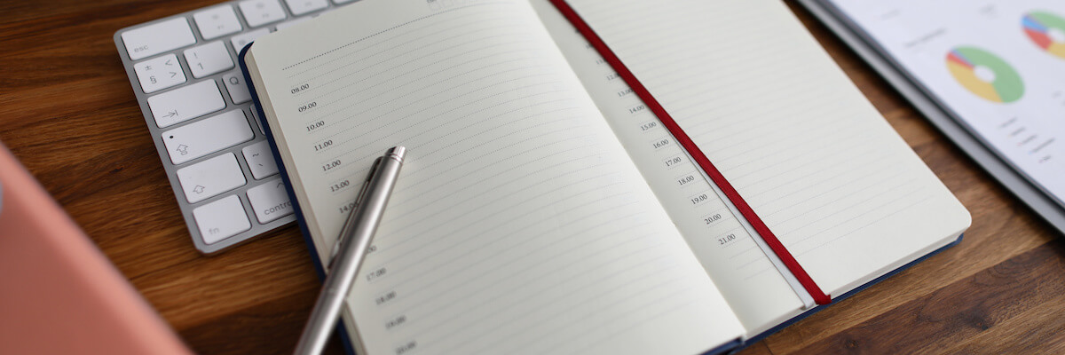 Overwhelmed at work: notebook and a pen
