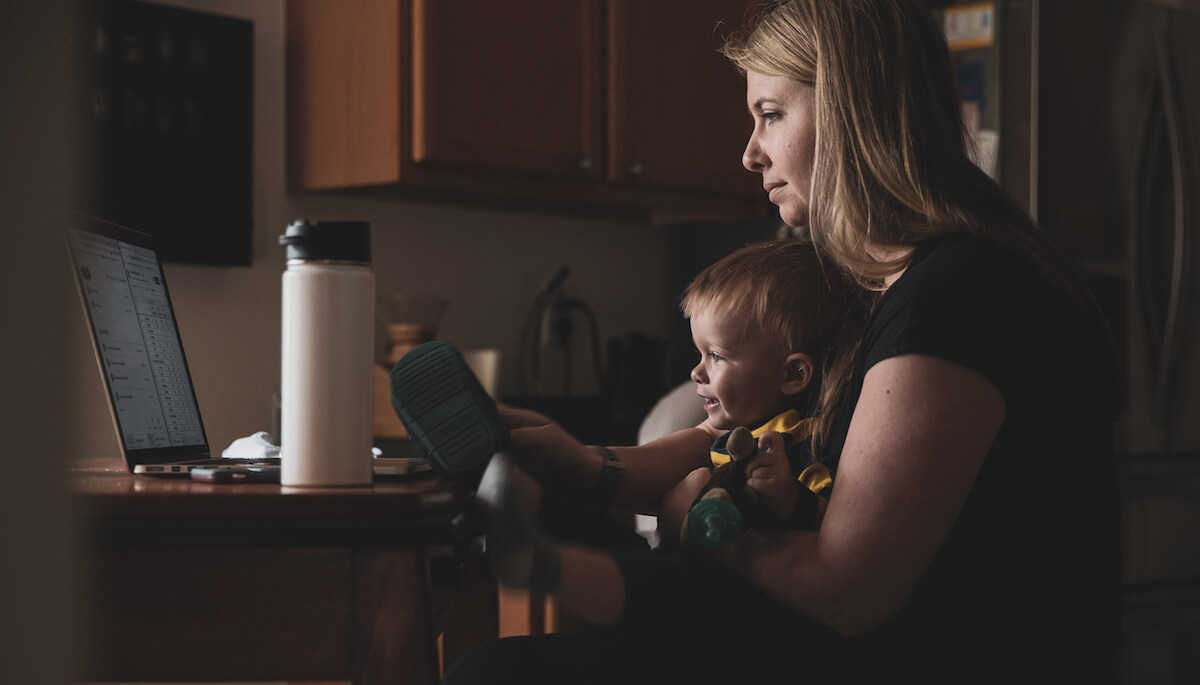 How to stay focused working from home: working mom with a baby on her lap