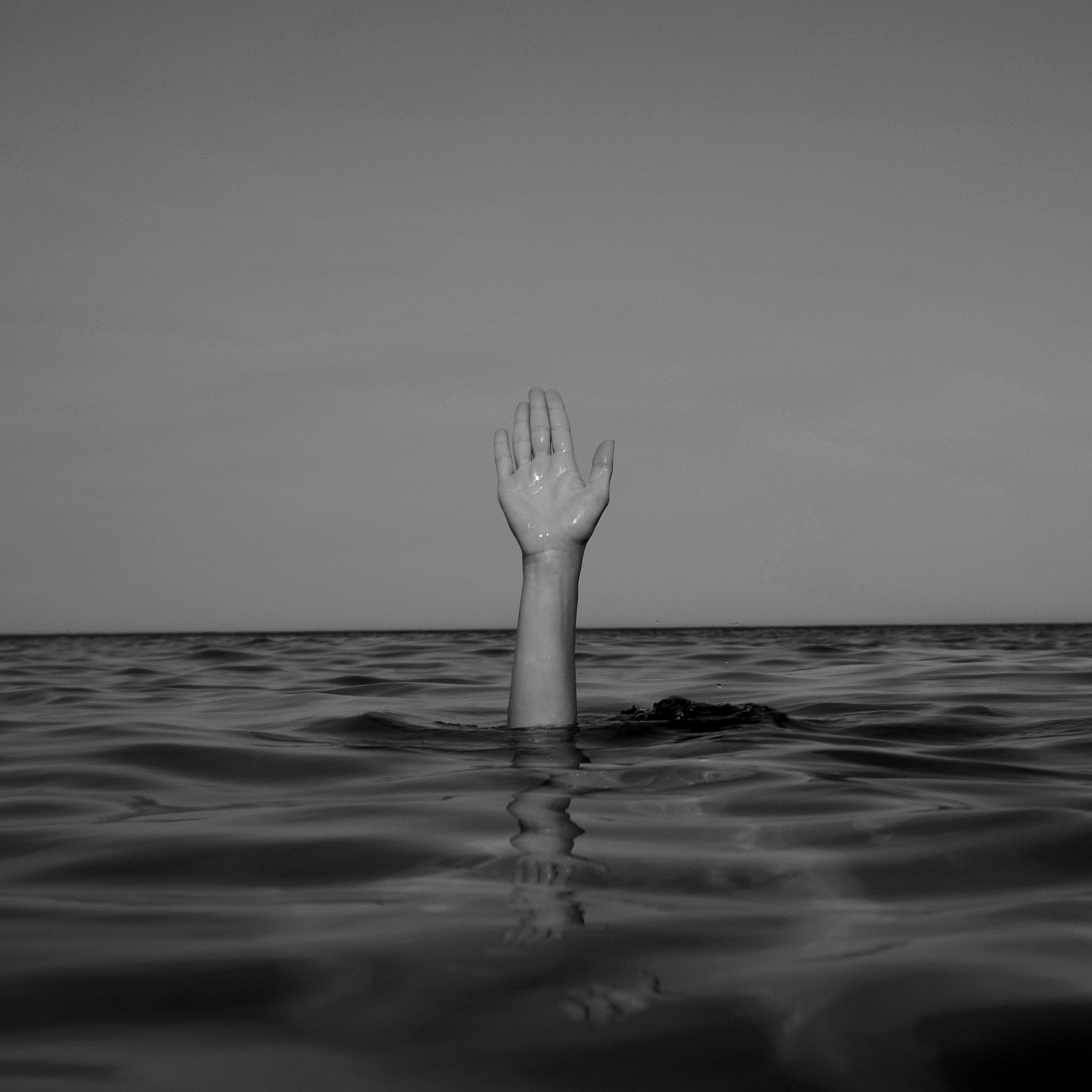 Hand in a large body of water