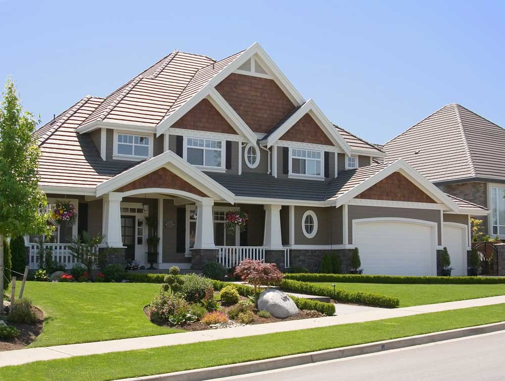 Dark grey and orange house with a green lawn.