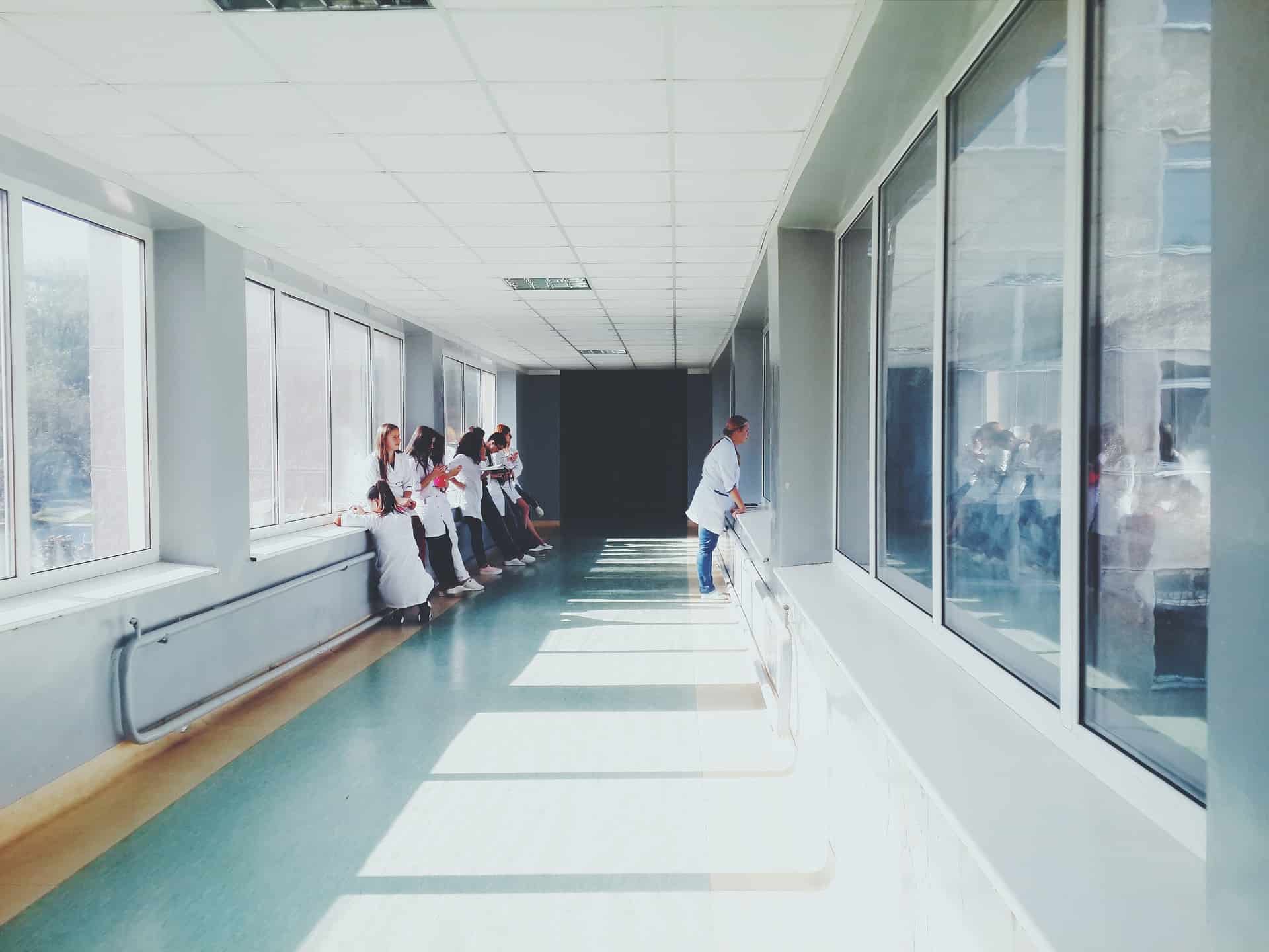 Doctors standing around in a hospital’s hallway.