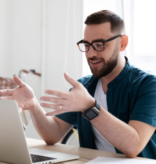 Man sitting in front of a laptop