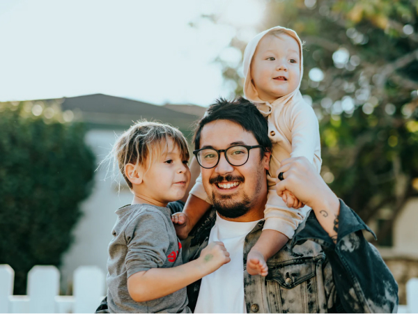 father holding kids