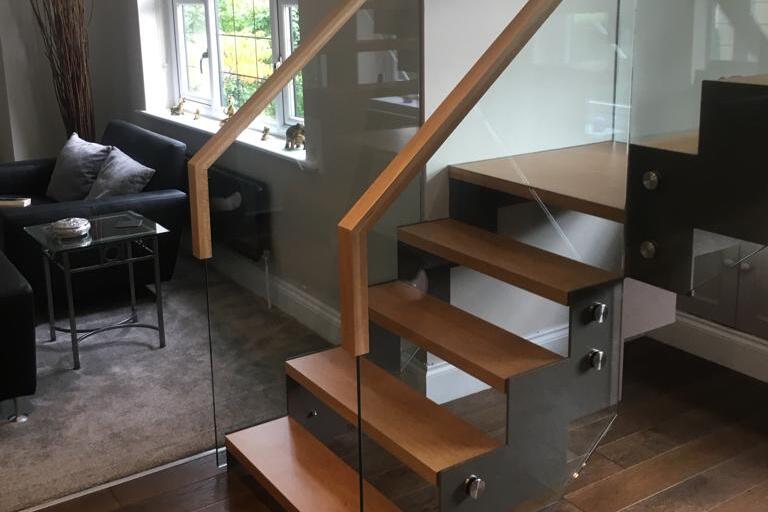 Metal Zigzag Stringer Staircase With Frameless Glass Balustrade and Oak