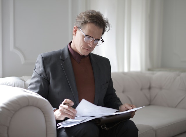 picture of a man reading document and reports