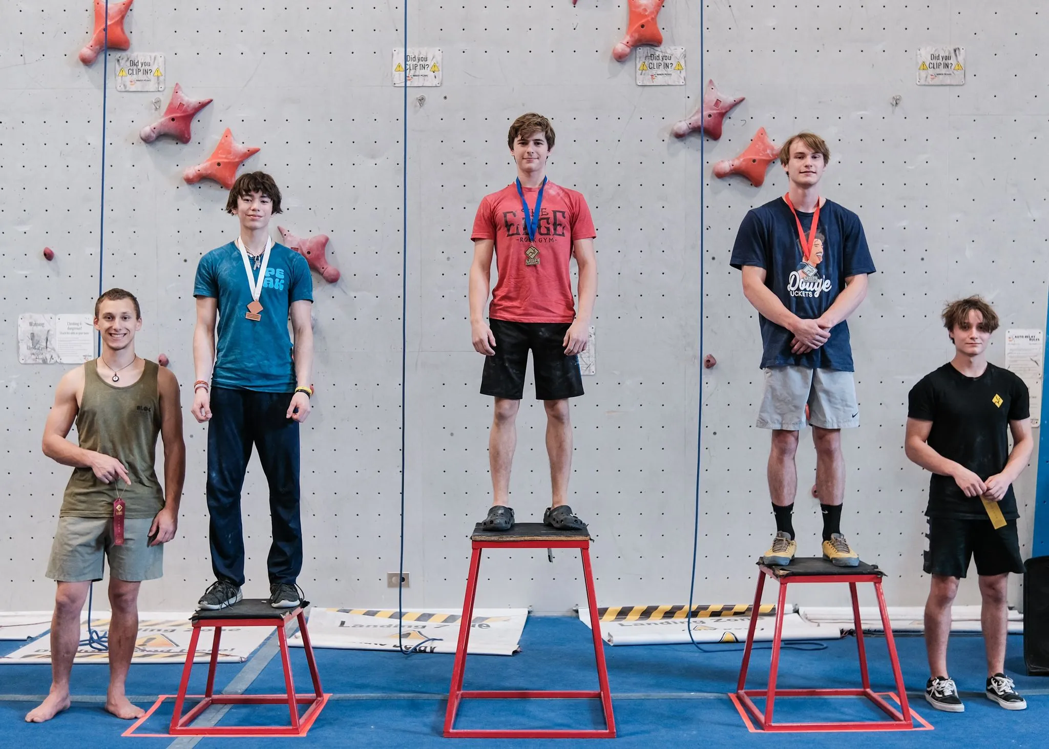 Five climbers on podiums for competition ranking. A member of Team Edge Miami is ranked first.