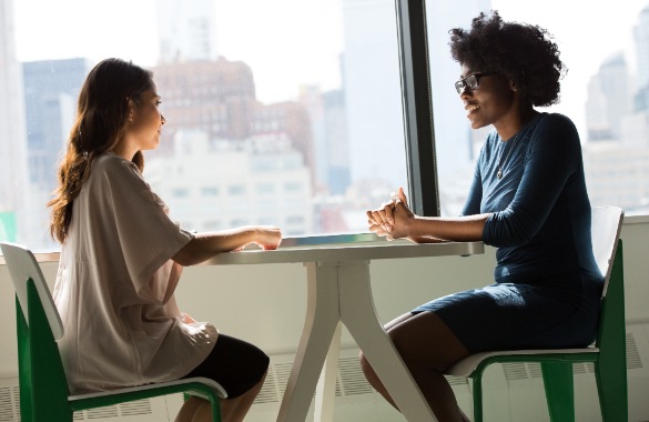 Two women at work having a serious discussion