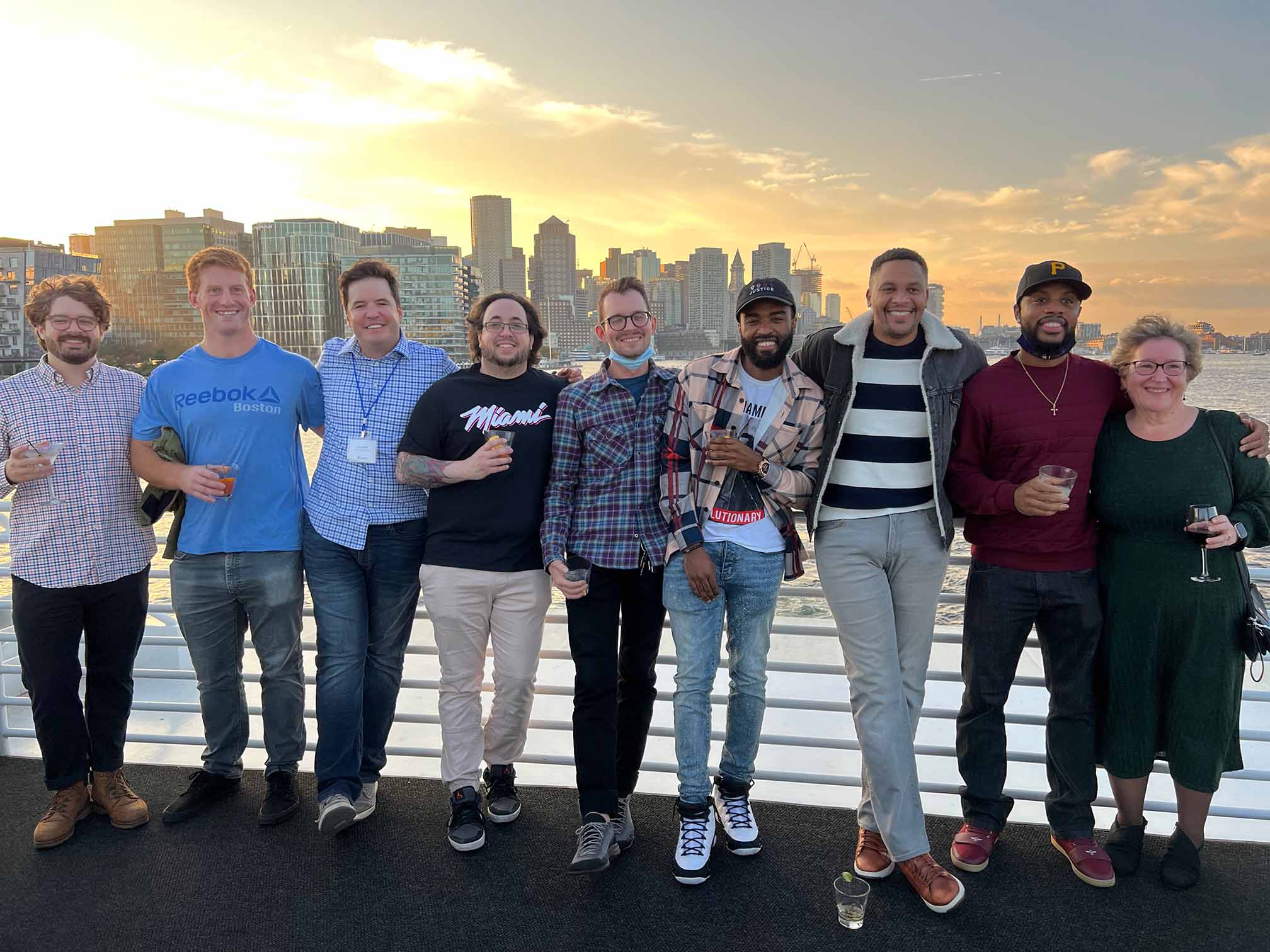 Team in front of sunset and city skyline