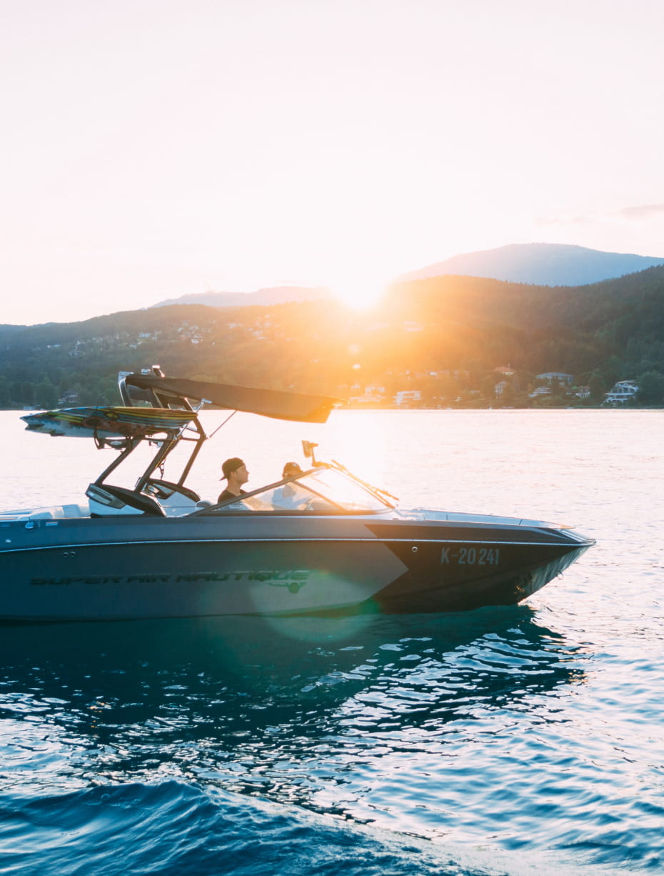 a powerboat out on the water at sunset