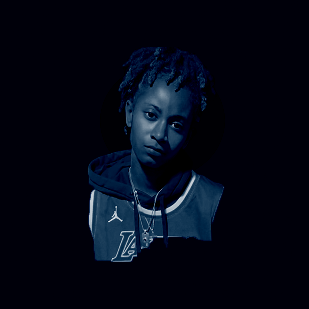 Artsit with a black drop light and blue light. head titled