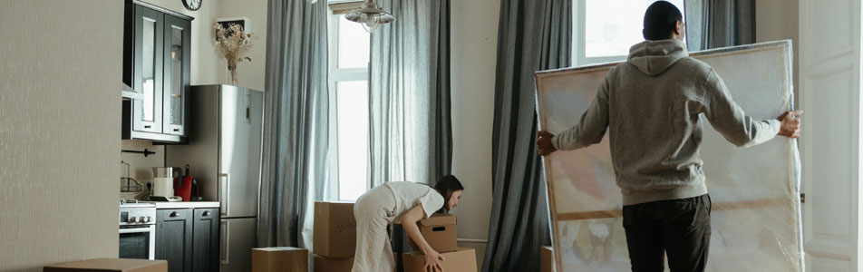 An image of two people moving out of their home