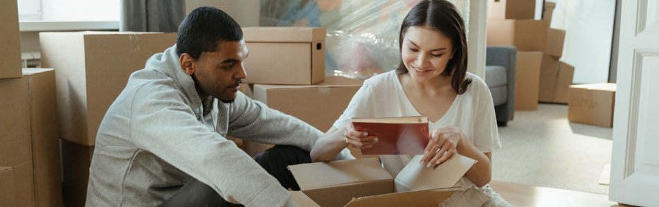 A couple unpacking boxes in their new home