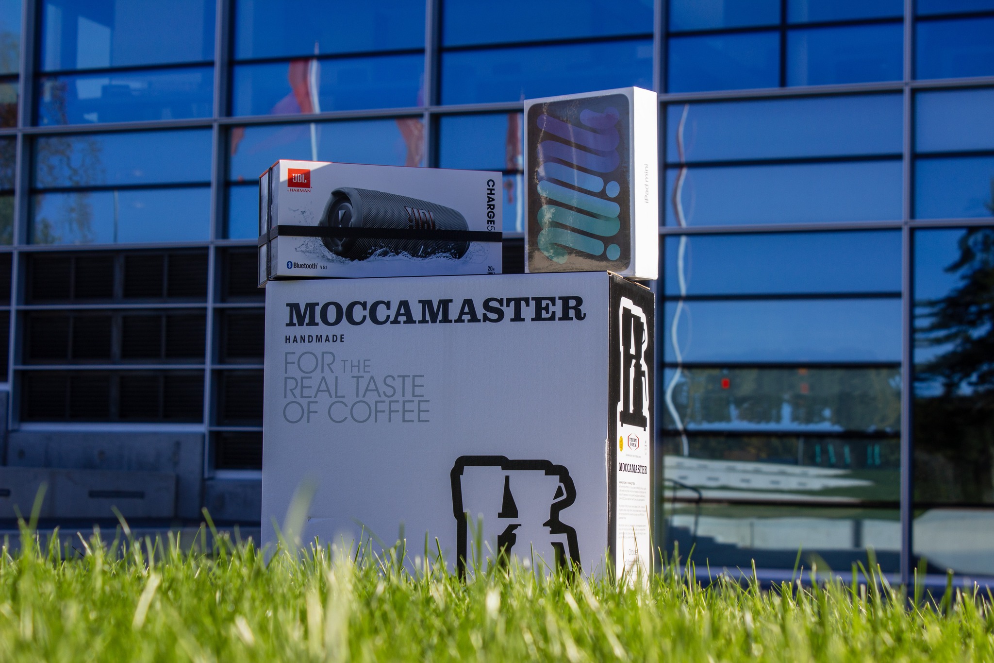 En Moccamaster, en JBL högtalare och en iPad som står på en gräsmatta framför fönsterna på Ångströmlaboratoriet hus 10. Dessa saker kan man vinna som pris om man anmäler sig till kontaktsamtalen