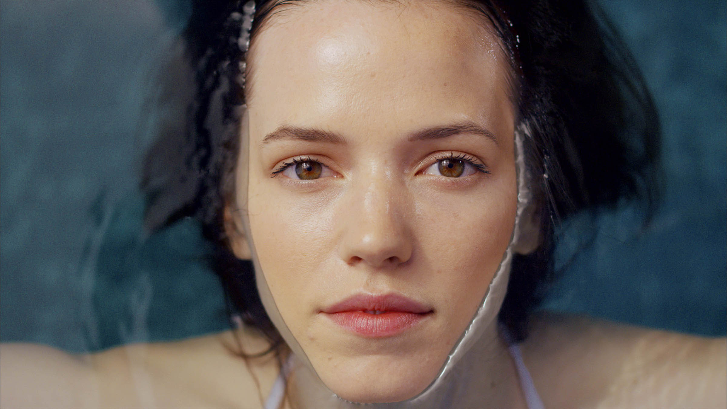 woman's face looking up from a pool