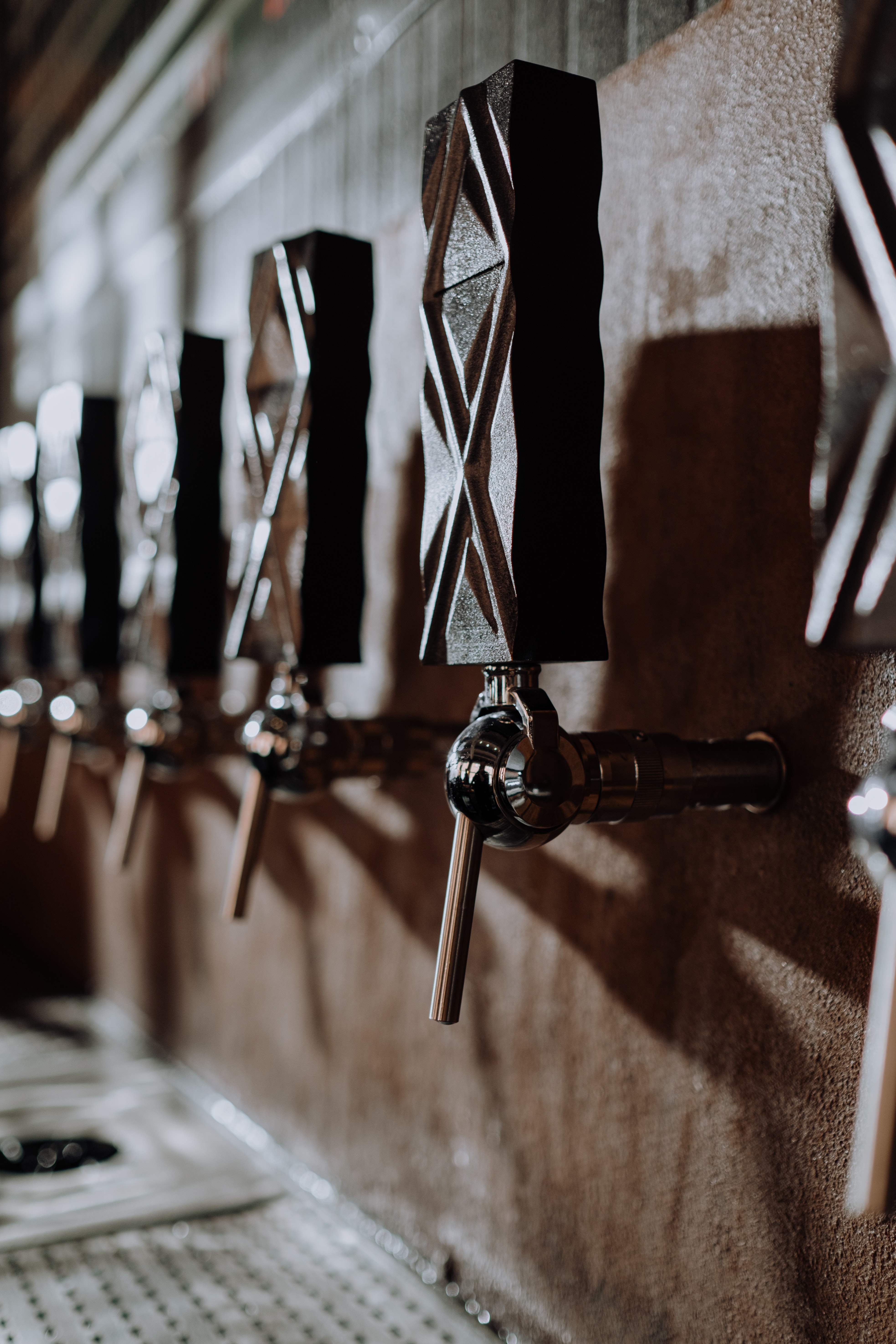 Beer tap made from wood with deep diagonal grooves.