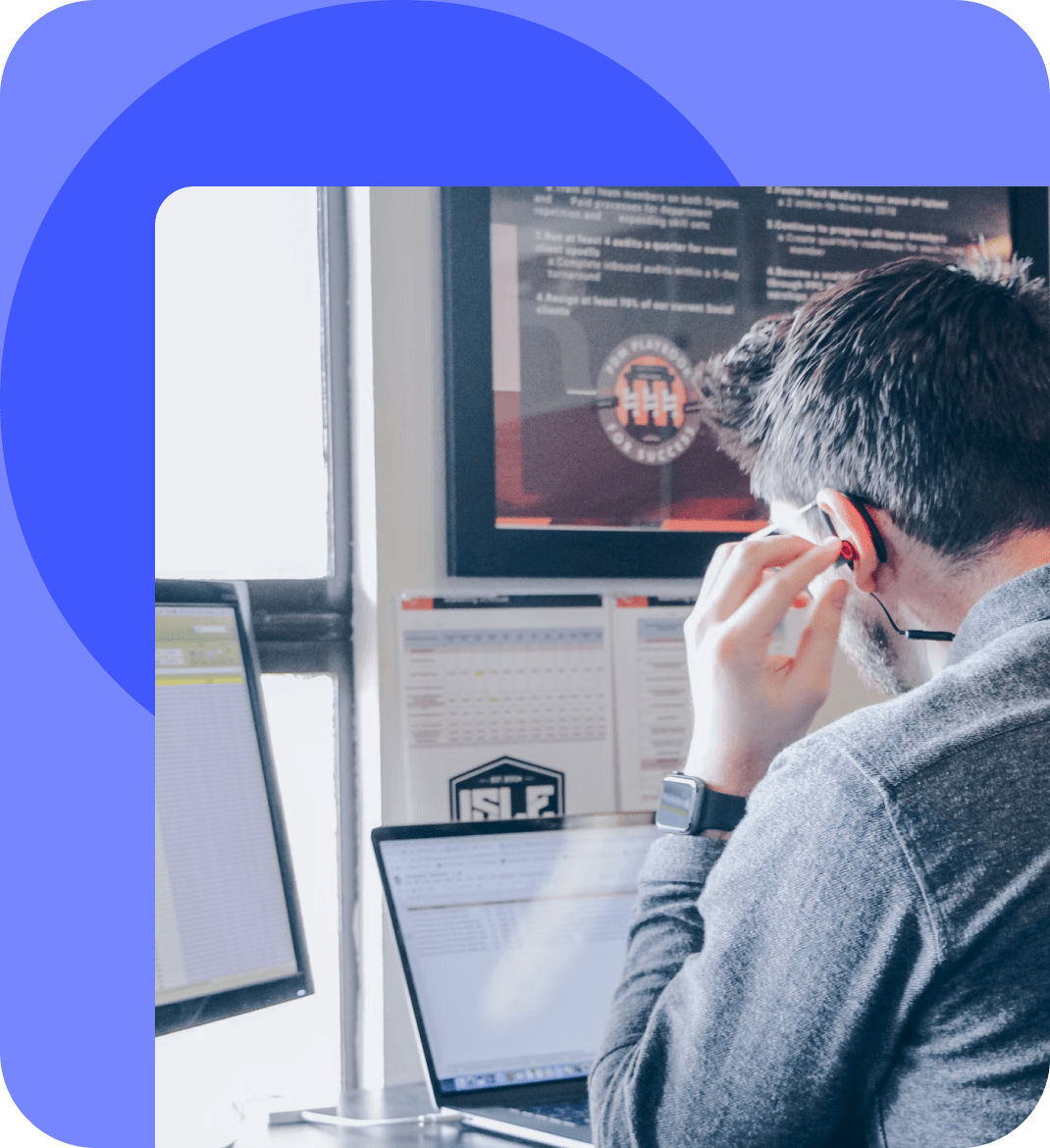 Man on the phone looking at a laptop