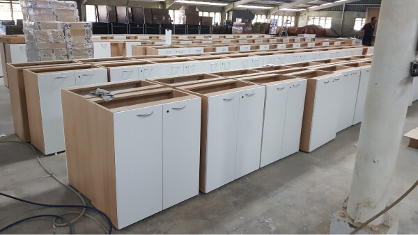 Rows of wooden cabinets, ready to be packaged and delivered to our client.