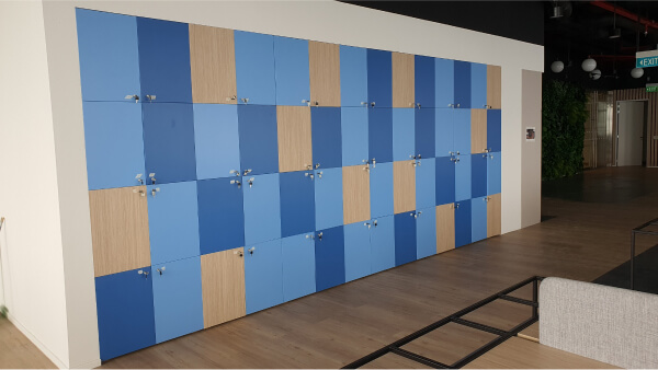 A long row of small wooden lockers with mixed colors per locker.