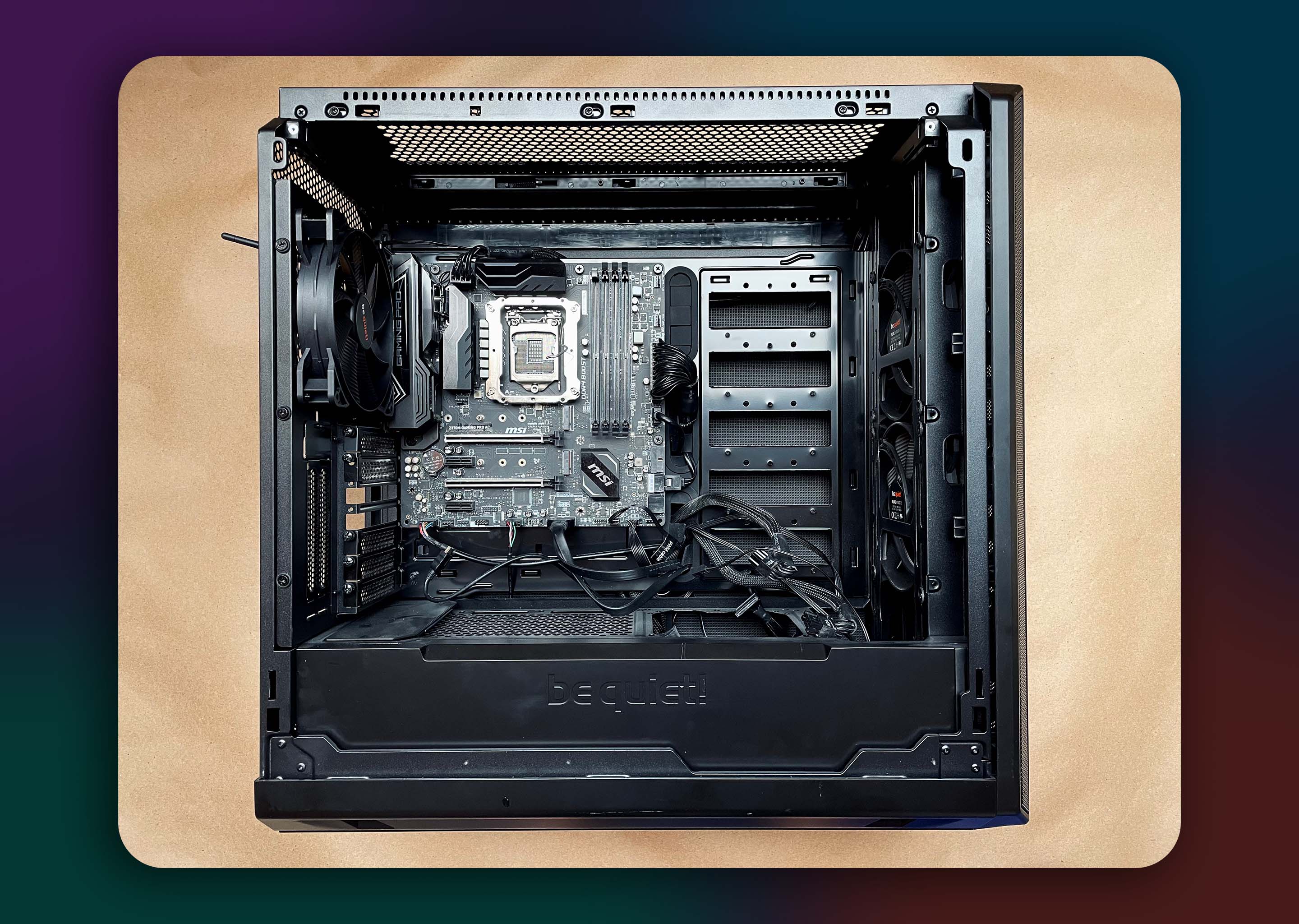 A computer with an open side panel. The motherboard, power supply, and case fans have been installed.