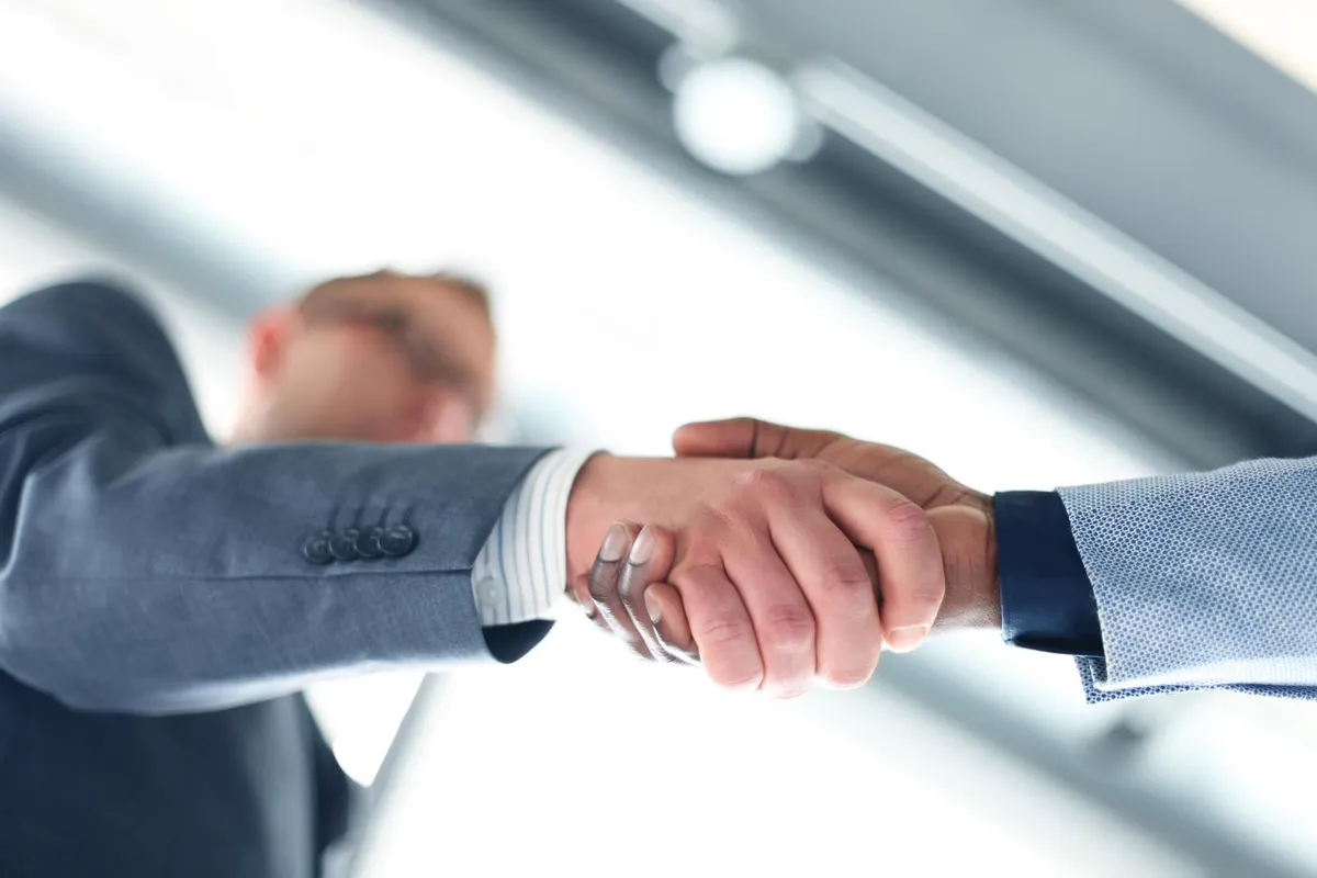 business handshake business man giving a handshake to close the deal