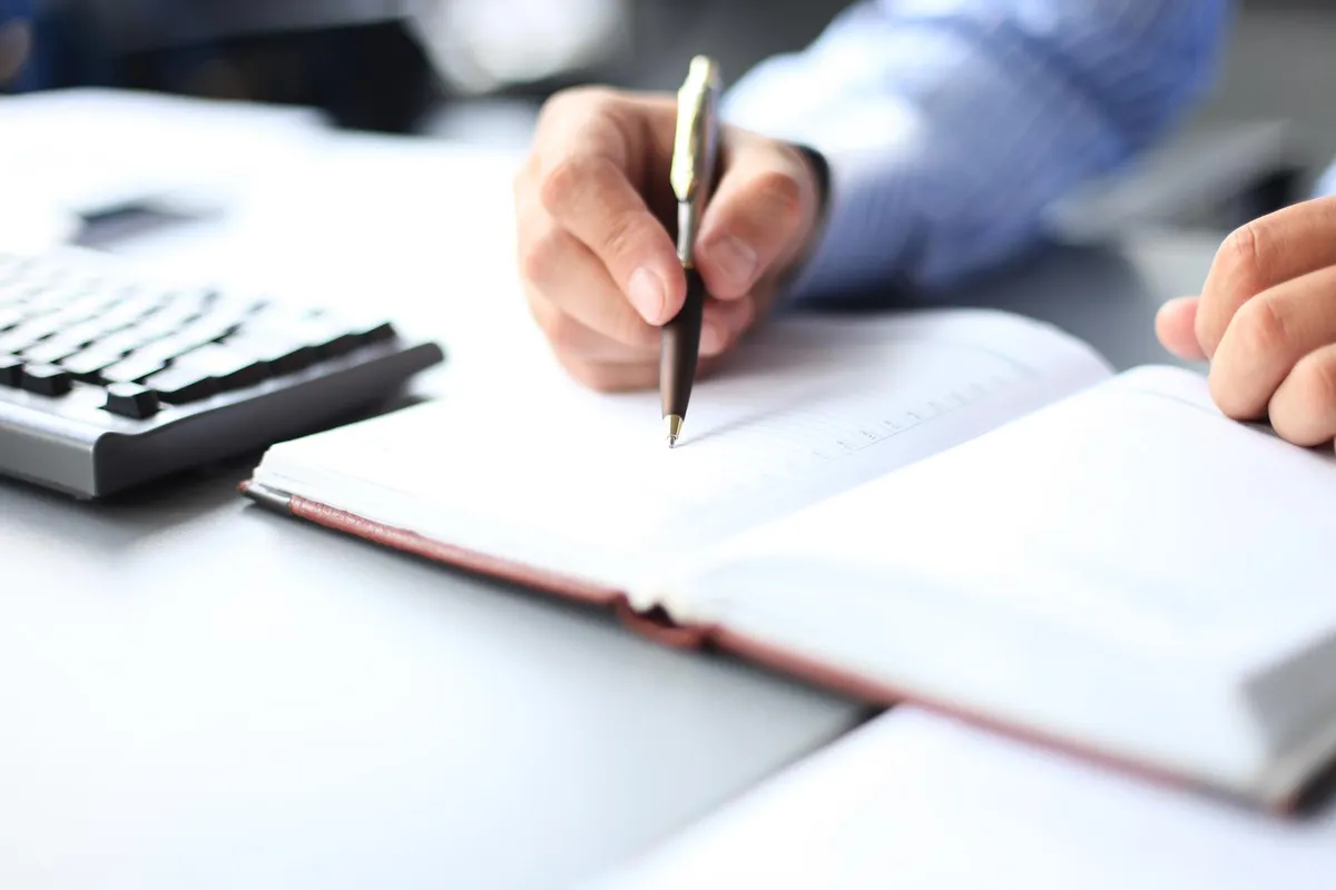 business lady taking notes at office