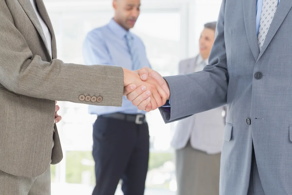 businessmen shaking their hands