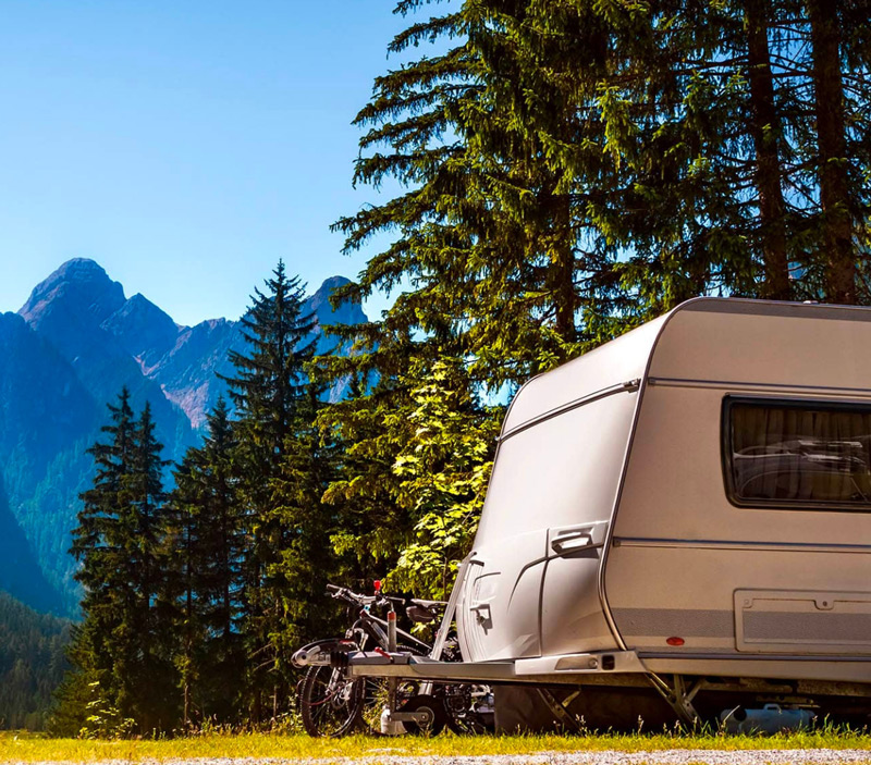 Touring caravan in a forest