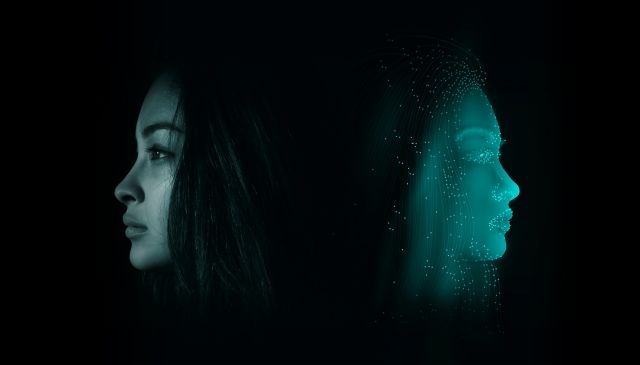 A human standing back-to-back with an avatar of herself